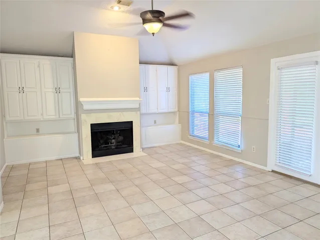 a view of an empty room with a fireplace