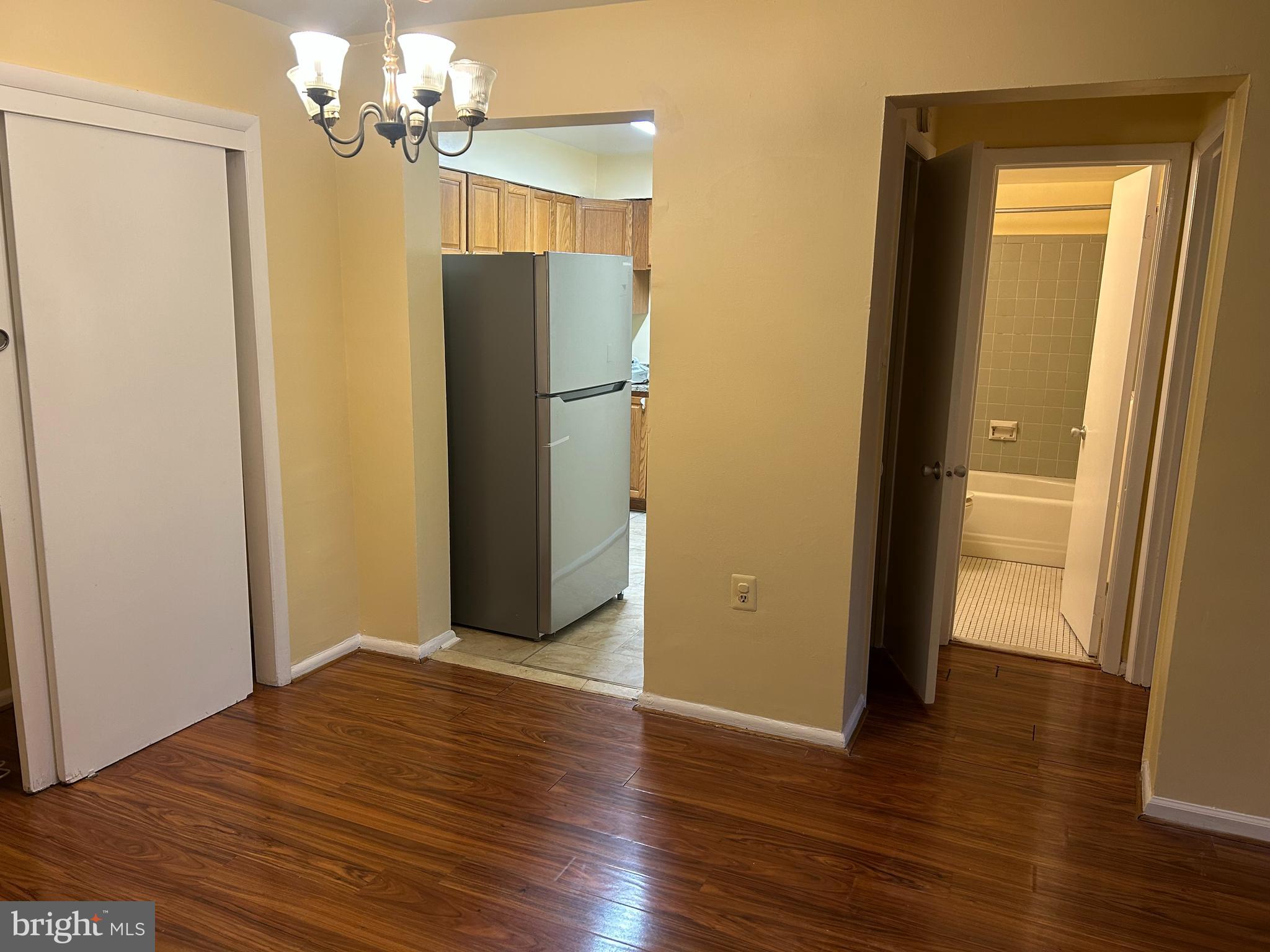 9250 Edwards Way, Unit 103A Hyattsville, MD 20783 - Photo 3 of 8 a view of a room with wooden floor
