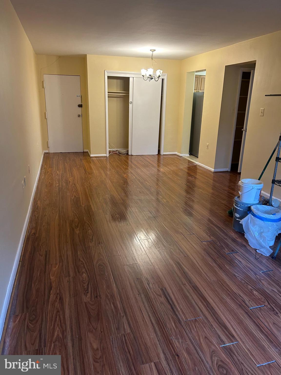 9250 Edwards Way, Unit 103A Hyattsville, MD 20783 - Photo 4 of 8 a view of an empty room with wooden floor