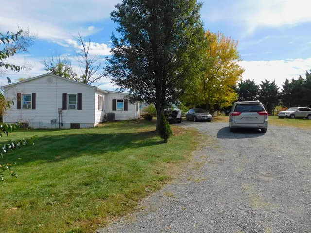 a view of house with outdoor space and garden