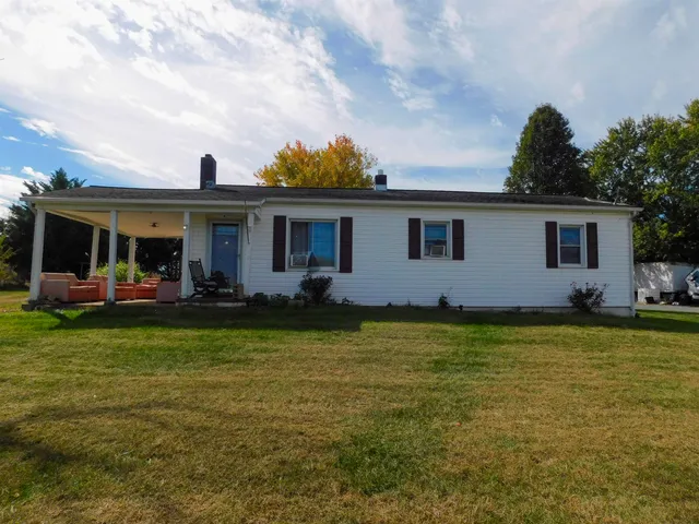 a front view of house with yard and outdoor seating