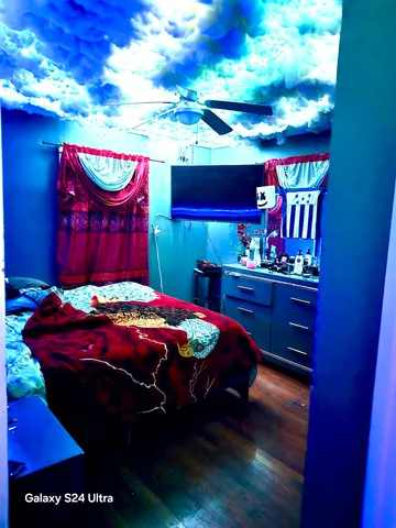 a bed sitting in a bedroom next to a lamp