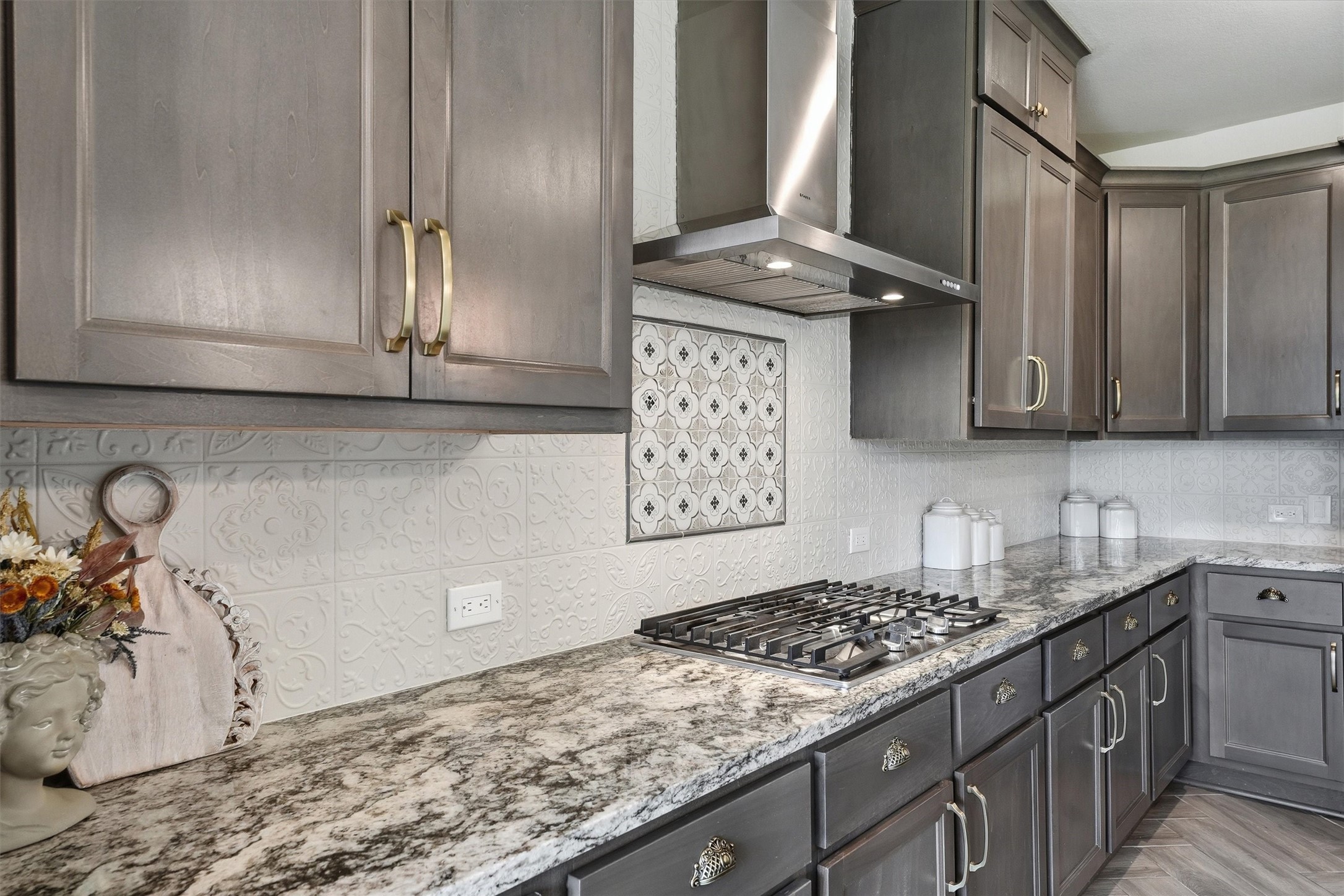 8673 Burdekin Road Magnolia, TX 77354 - Photo 14 of 50 Gas cooktop complete with modern vent hood.