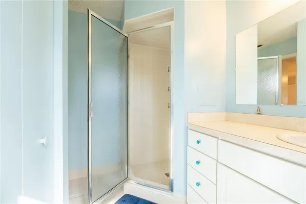 a bathroom with a shower and a sink