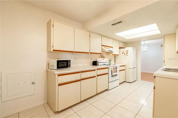 a kitchen with appliances cabinets and a sink