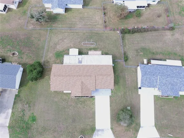 an aerial view of a house with a yard and lake view