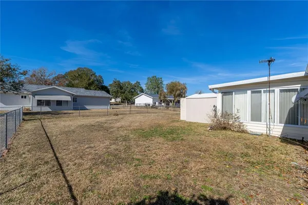 a view of house with a yard