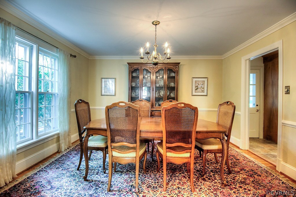 10021 Apache Road Richmond, VA 23235 - Photo 17 of 42 a dining room with furniture a chandelier and wooden floor