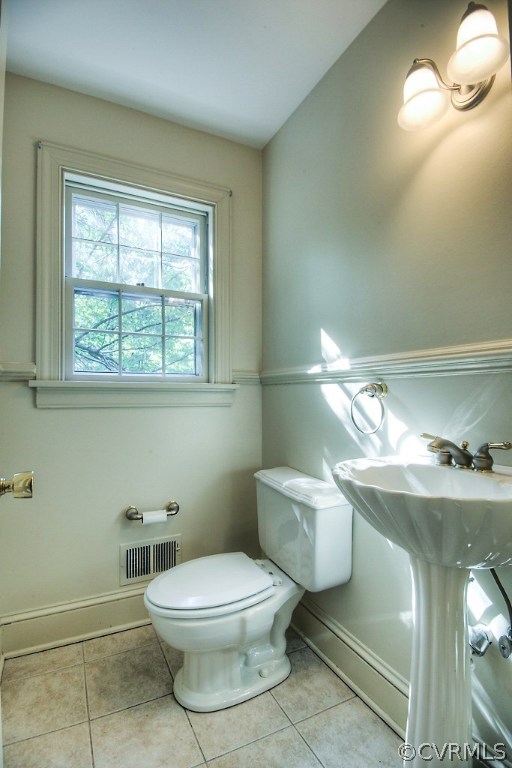10021 Apache Road Richmond, VA 23235 - Photo 27 of 42 a white toilet sitting next to a bathroom sink