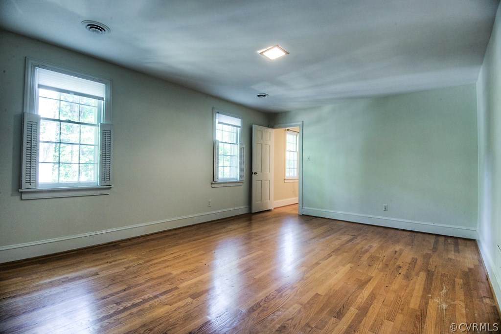 10021 Apache Road Richmond, VA 23235 - Photo 32 of 42 an empty room with wooden floor and windows