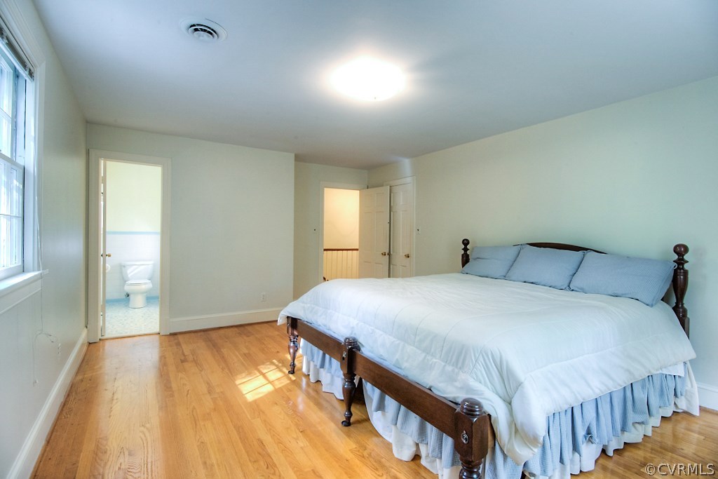 10021 Apache Road Richmond, VA 23235 - Photo 35 of 42 a bedroom with a bed and wooden floor