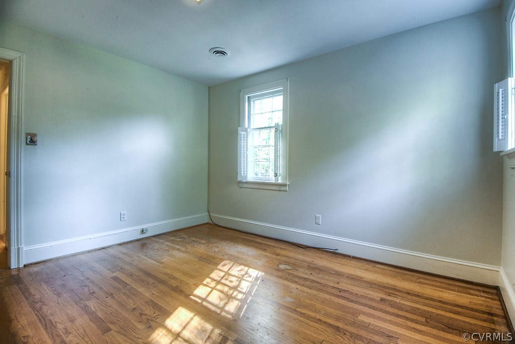 10021 Apache Road Richmond, VA 23235 - Photo 40 of 42 an empty room with wooden floor and windows