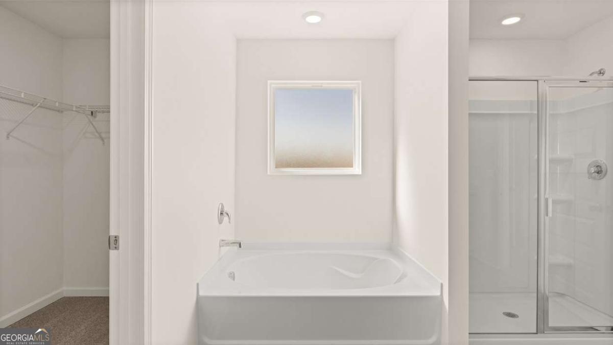 11929 Aukerman Way Hampton, GA 30228 - Photo 9 of 13 a bathroom with a bathtub