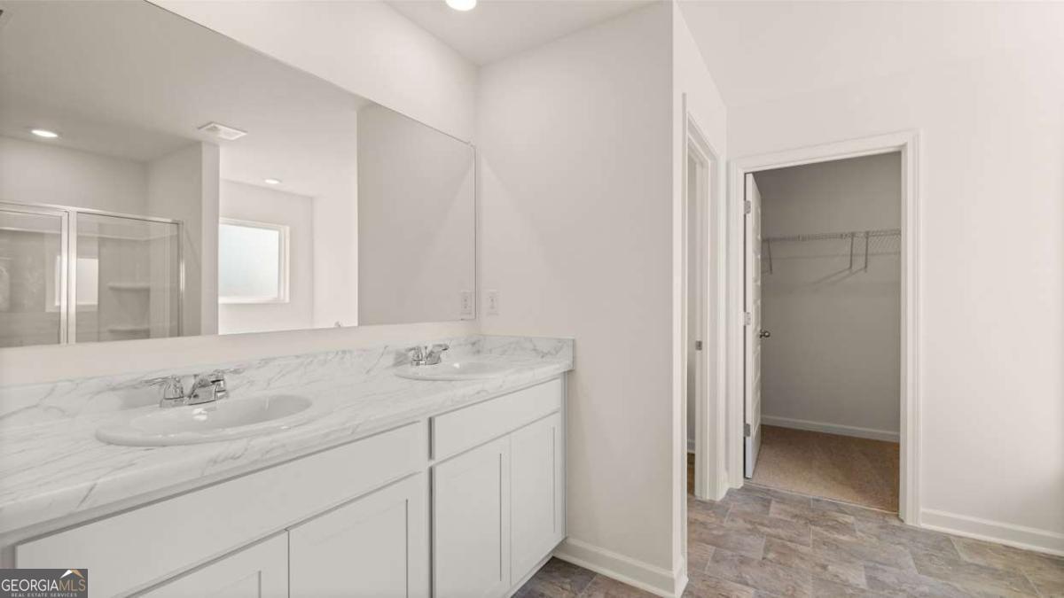 11929 Aukerman Way Hampton, GA 30228 - Photo 10 of 13 a bathroom with a sink and a mirror