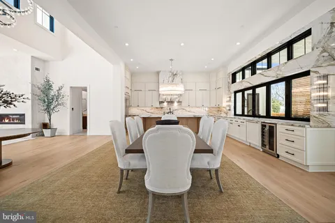 a dining room with furniture and a floor to ceiling window
