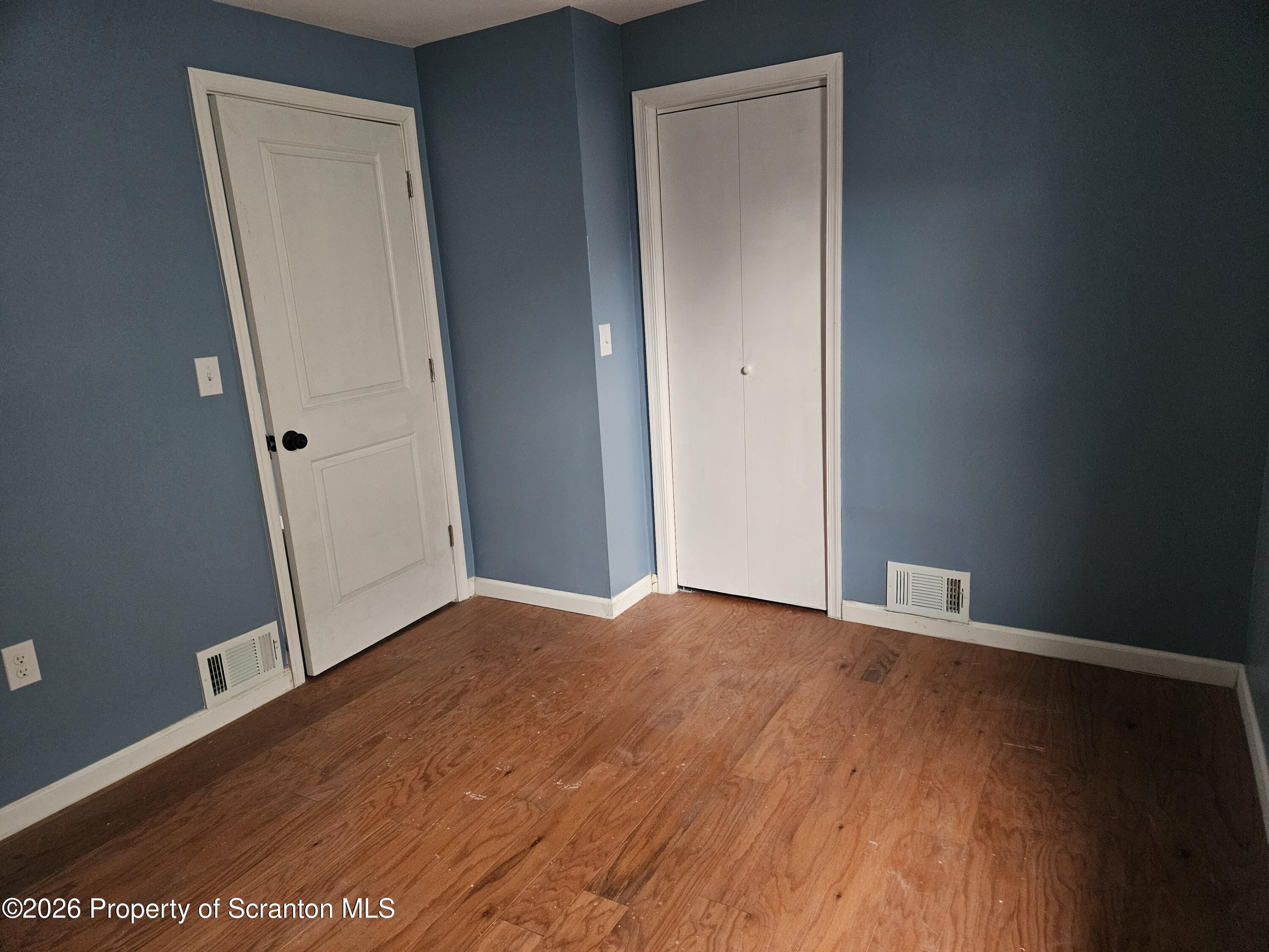 335 Phelps Street, Unit 2 REAR Scranton, PA 18509 - Photo 11 of 13 an empty room with wooden floor and closet
