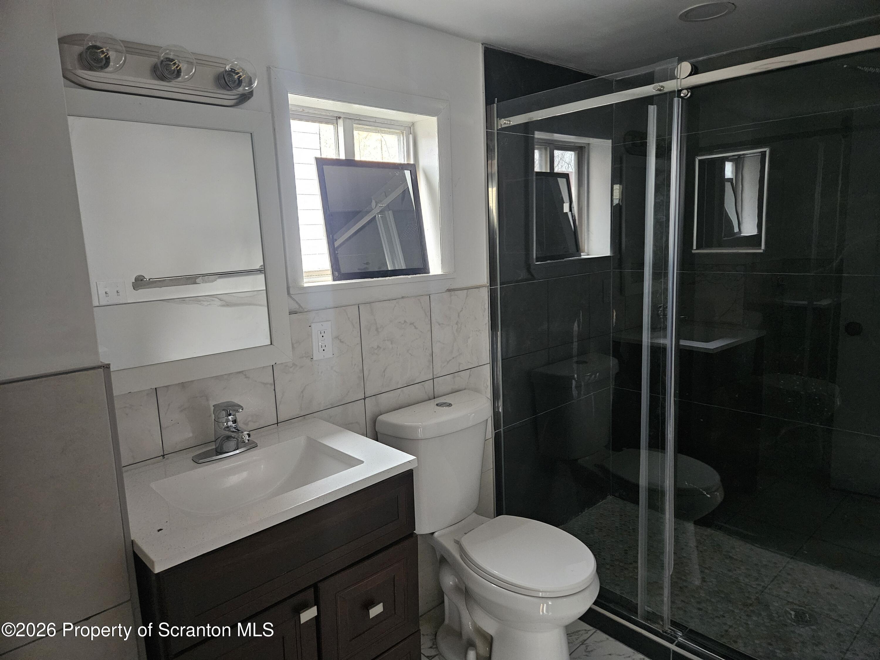335 Phelps Street, Unit 2 REAR Scranton, PA 18509 - Photo 12 of 13 a bathroom with a sink toilet and shower
