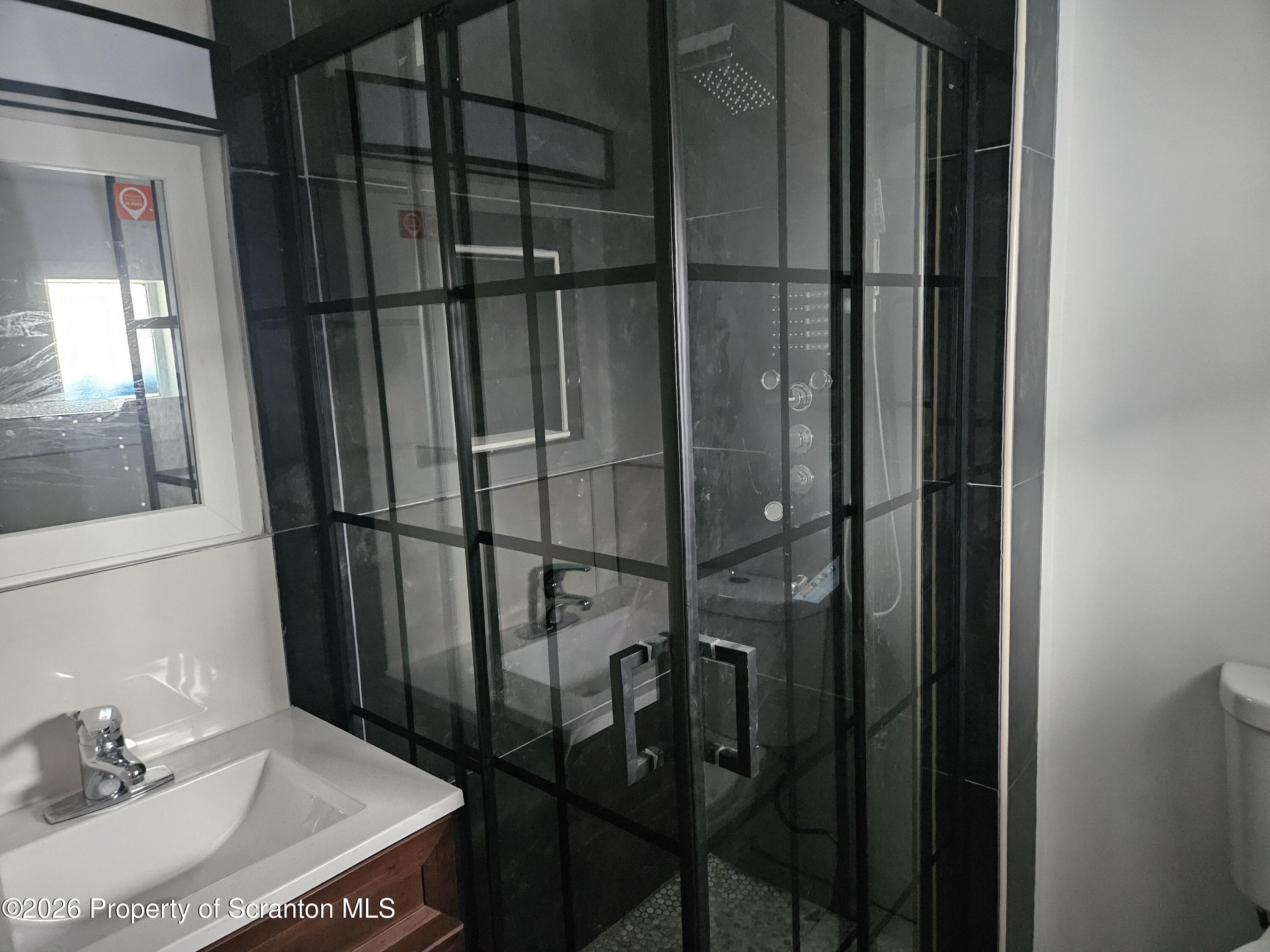 335 Phelps Street, Unit 2 REAR Scranton, PA 18509 - Photo 13 of 13 a bathroom with a sink and mirror