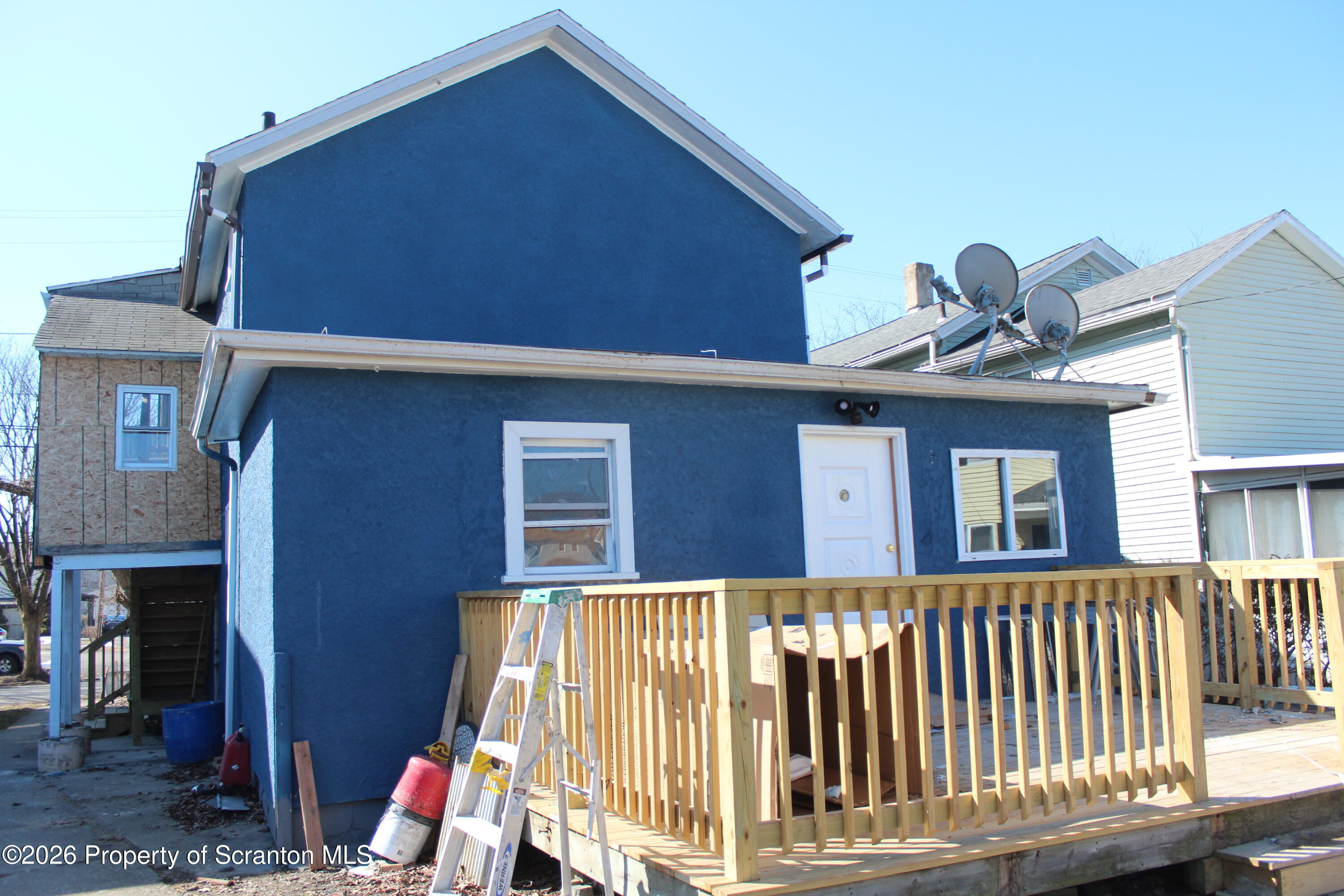 335 Phelps Street, Unit 2 REAR Scranton, PA 18509 - Photo 2 of 13 a view of a house with a small yard and wooden fence