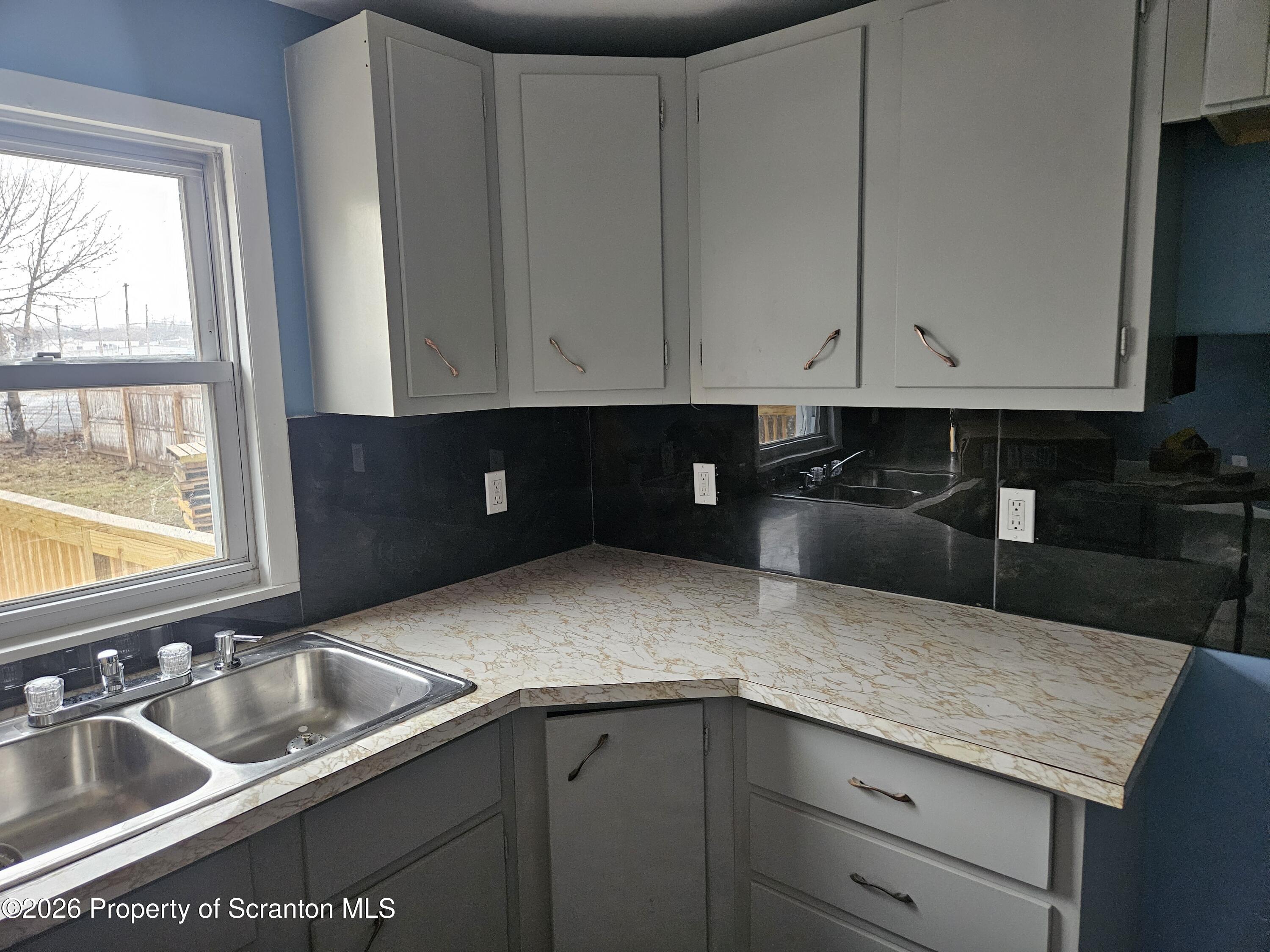 335 Phelps Street, Unit 2 REAR Scranton, PA 18509 - Photo 4 of 13 a kitchen with granite countertop a sink and a stove