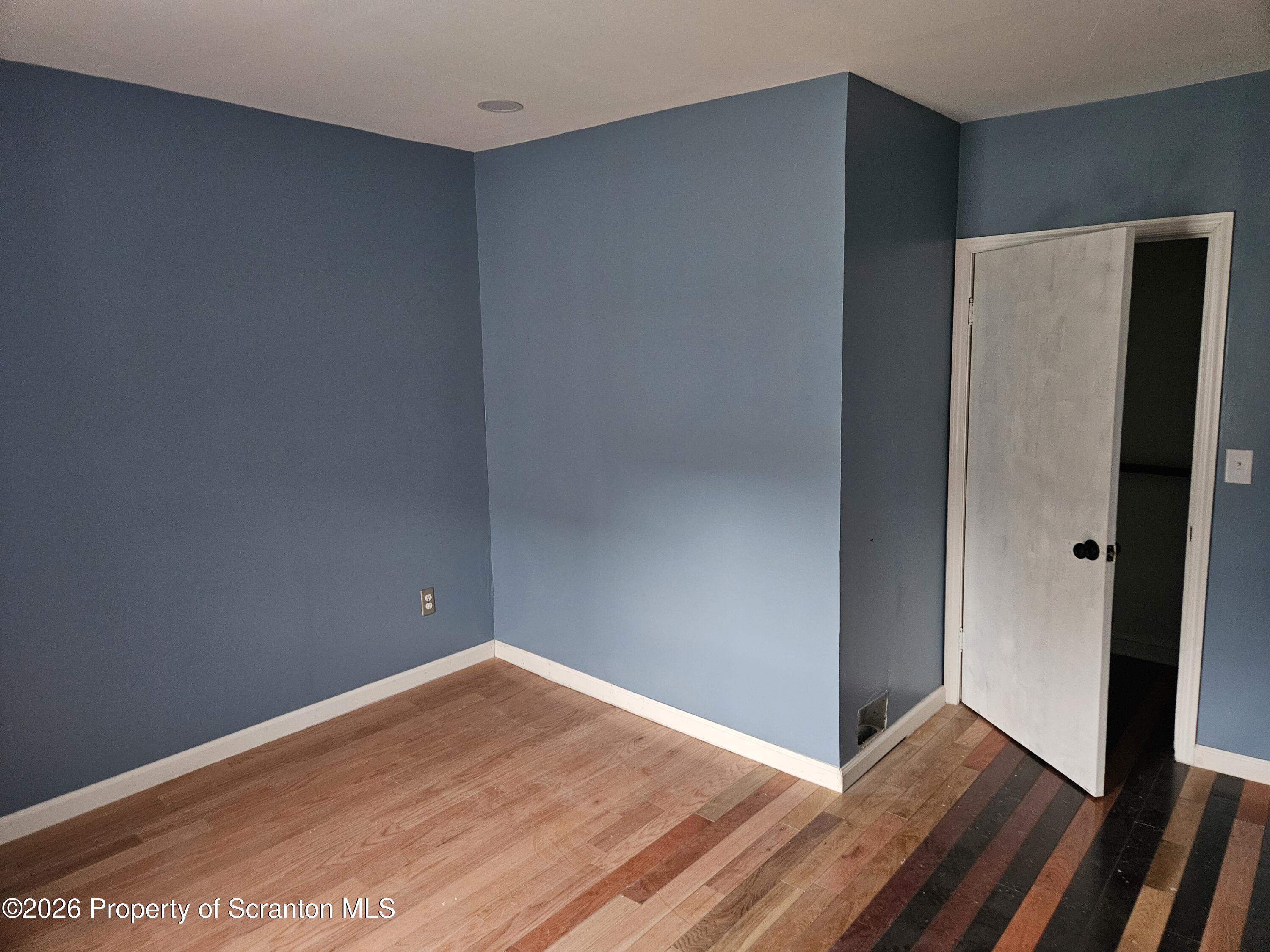 335 Phelps Street, Unit 2 REAR Scranton, PA 18509 - Photo 9 of 13 a view of an empty room with wooden floor and closet