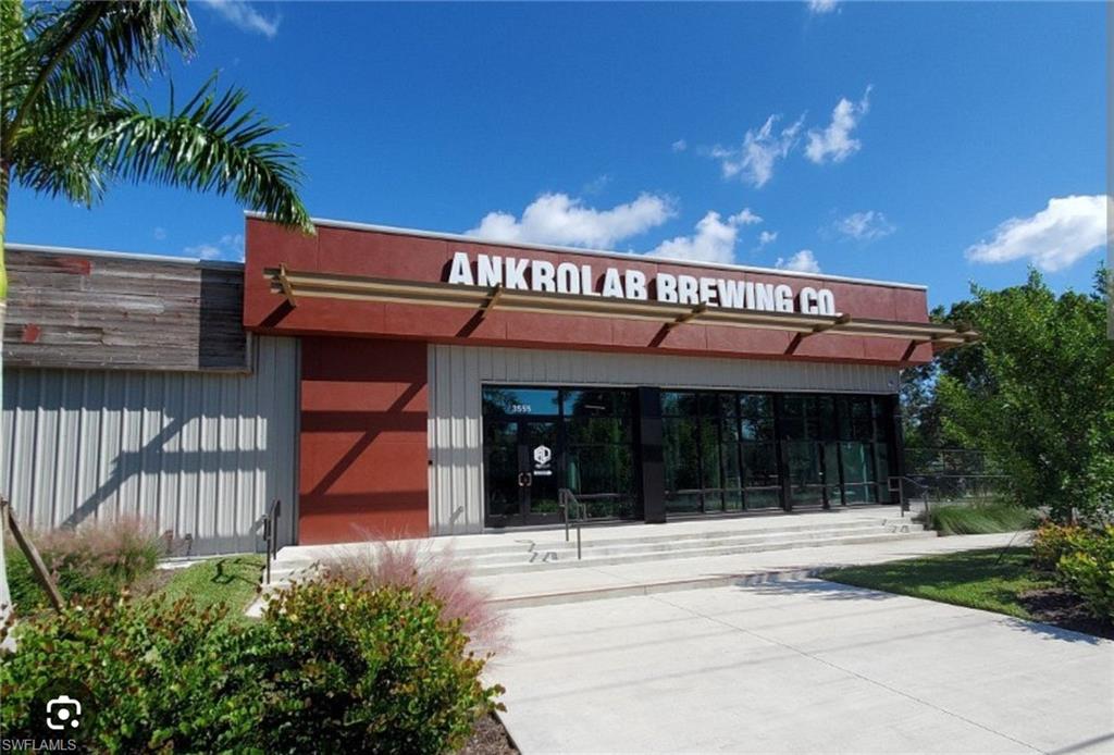 4021 Full Moon Court Naples, FL 34112 - Photo 12 of 23 front view of a building with a glass door