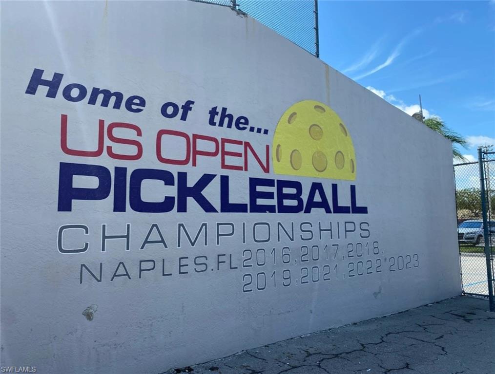 4021 Full Moon Court Naples, FL 34112 - Photo 20 of 23 a view of a wooden door and sign board