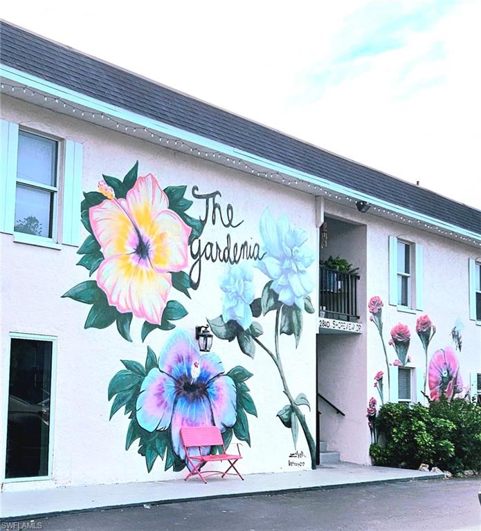 4021 Full Moon Court Naples, FL 34112 - Photo 8 of 23 a vase of flowers sitting on a shelf