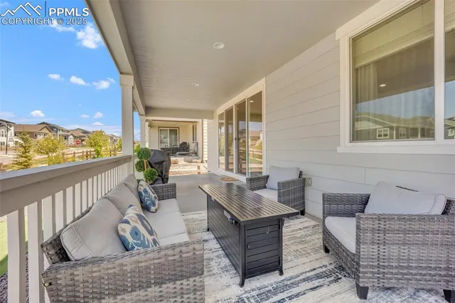 a living room with furniture and a floor to ceiling window