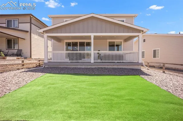 an aerial view of a house with a yard