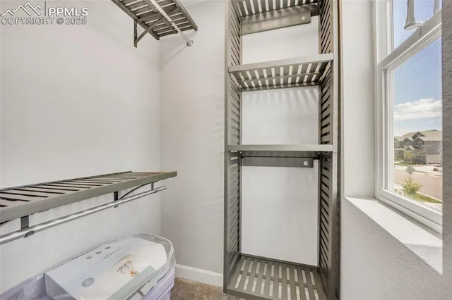 a view of a terrace with furniture and a floor to ceiling window