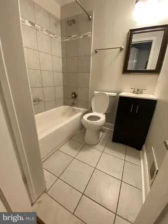 a bathroom with a toilet a sink and bathtub