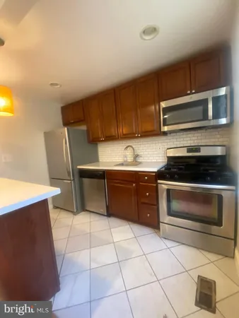 a kitchen with a cabinets and steel appliances