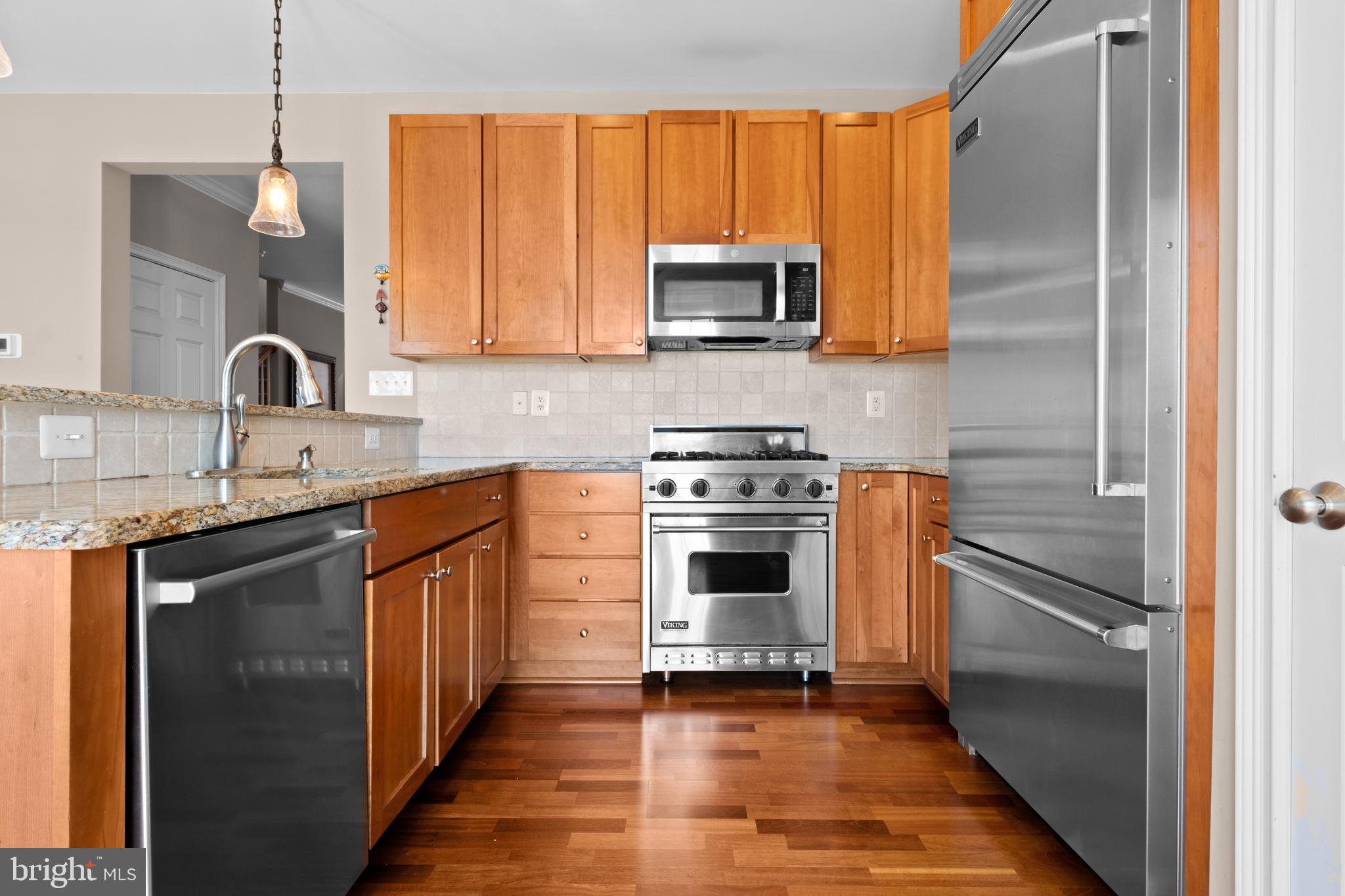 203 Captains Way Philadelphia, PA 19146 - Photo 13 of 58 a kitchen with stainless steel appliances granite countertop a stove a sink and a refrigerator