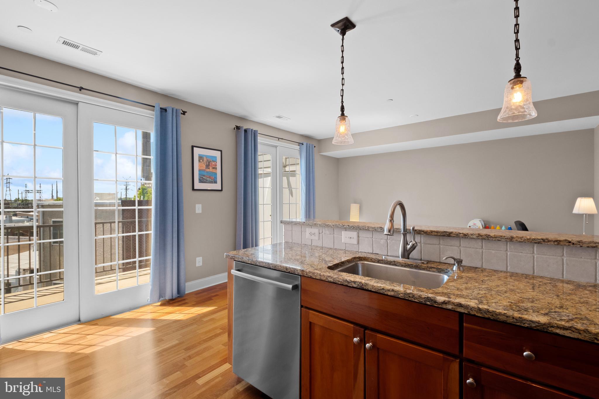 203 Captains Way Philadelphia, PA 19146 - Photo 15 of 58 a kitchen with granite countertop a sink a window and stainless steel appliances