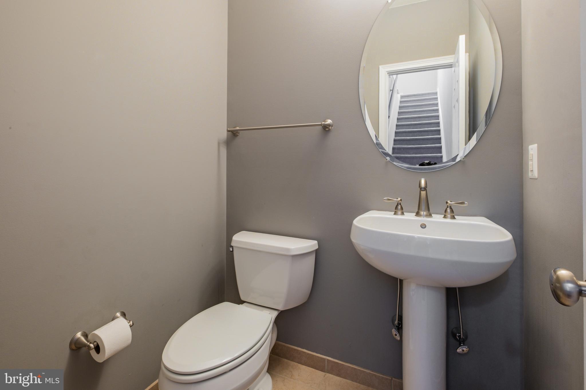 203 Captains Way Philadelphia, PA 19146 - Photo 23 of 58 a bathroom with a toilet a sink and mirror