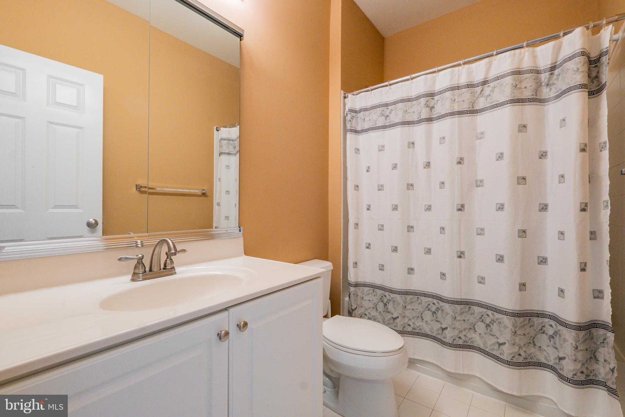 203 Captains Way Philadelphia, PA 19146 - Photo 32 of 58 a bathroom with a sink a toilet and shower curtain
