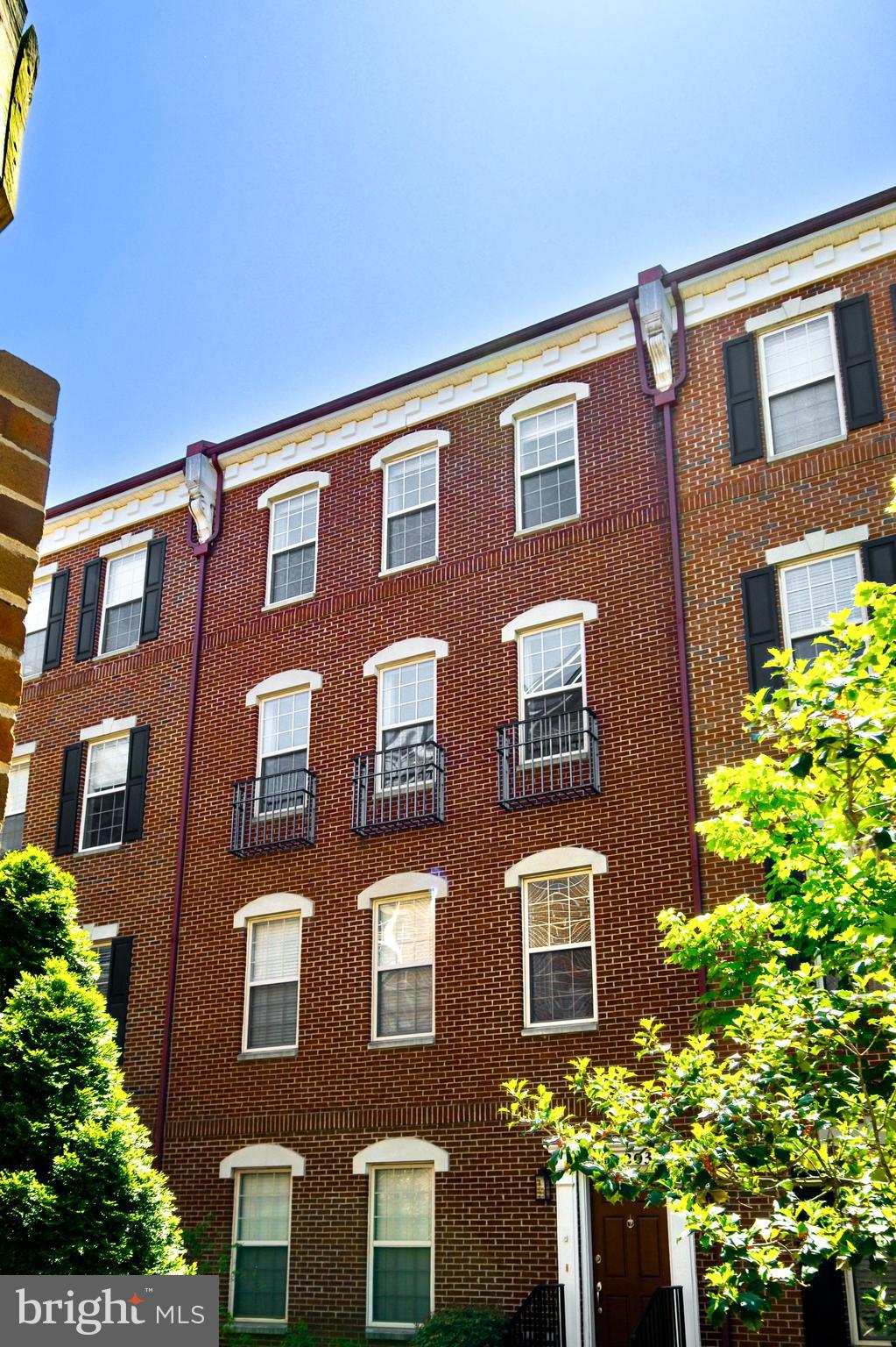 203 Captains Way Philadelphia, PA 19146 - Photo 39 of 58 a front view of a building with a lot of flowers and trees