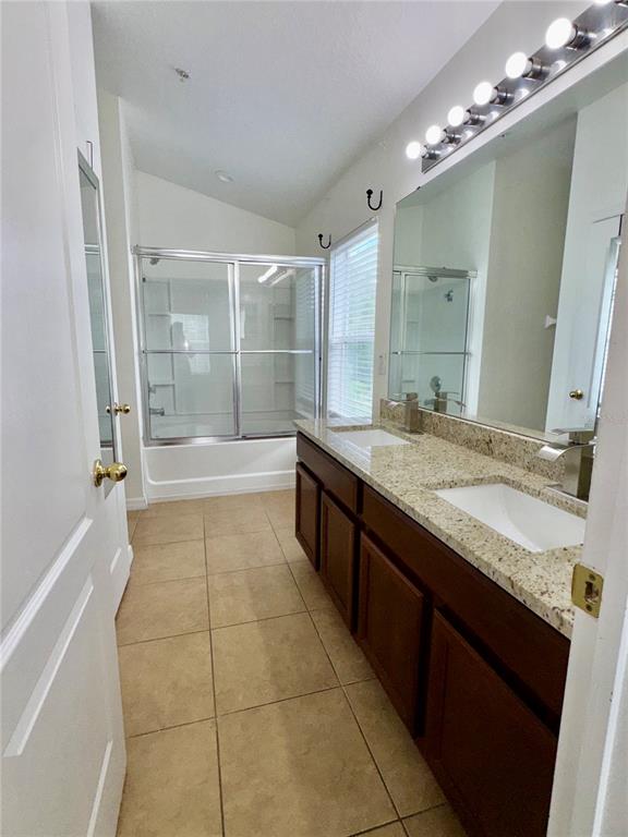 6404 South Goldenrod Road, Unit 2A Orlando, FL 32822 - Photo 20 of 40 a spacious bathroom with a granite countertop sink a toilet a mirror and shower
