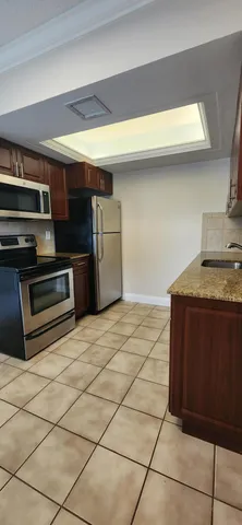 a kitchen with stainless steel appliances a stove a microwave and a refrigerator