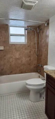 a bathroom with a toilet a sink and shower