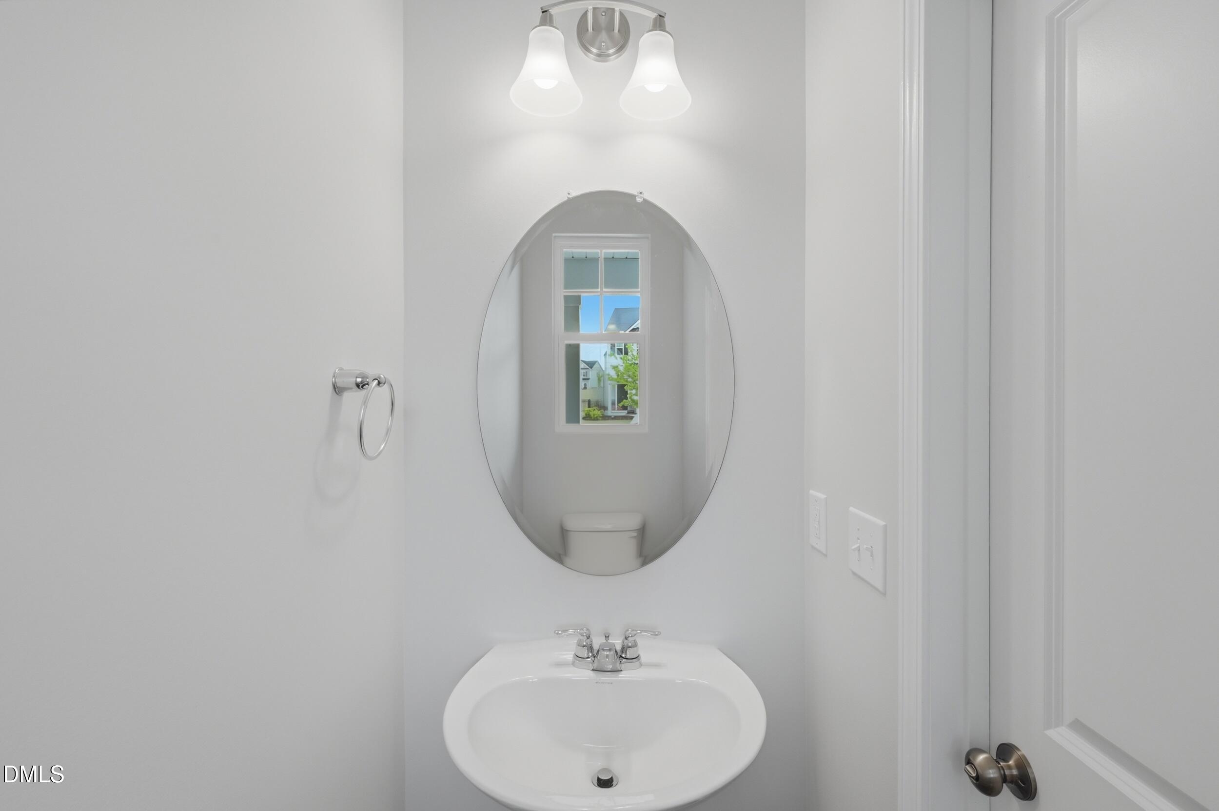 5011 Kota Street Raleigh, NC 27610 - Photo 12 of 42 a bathroom with a sink and a mirror