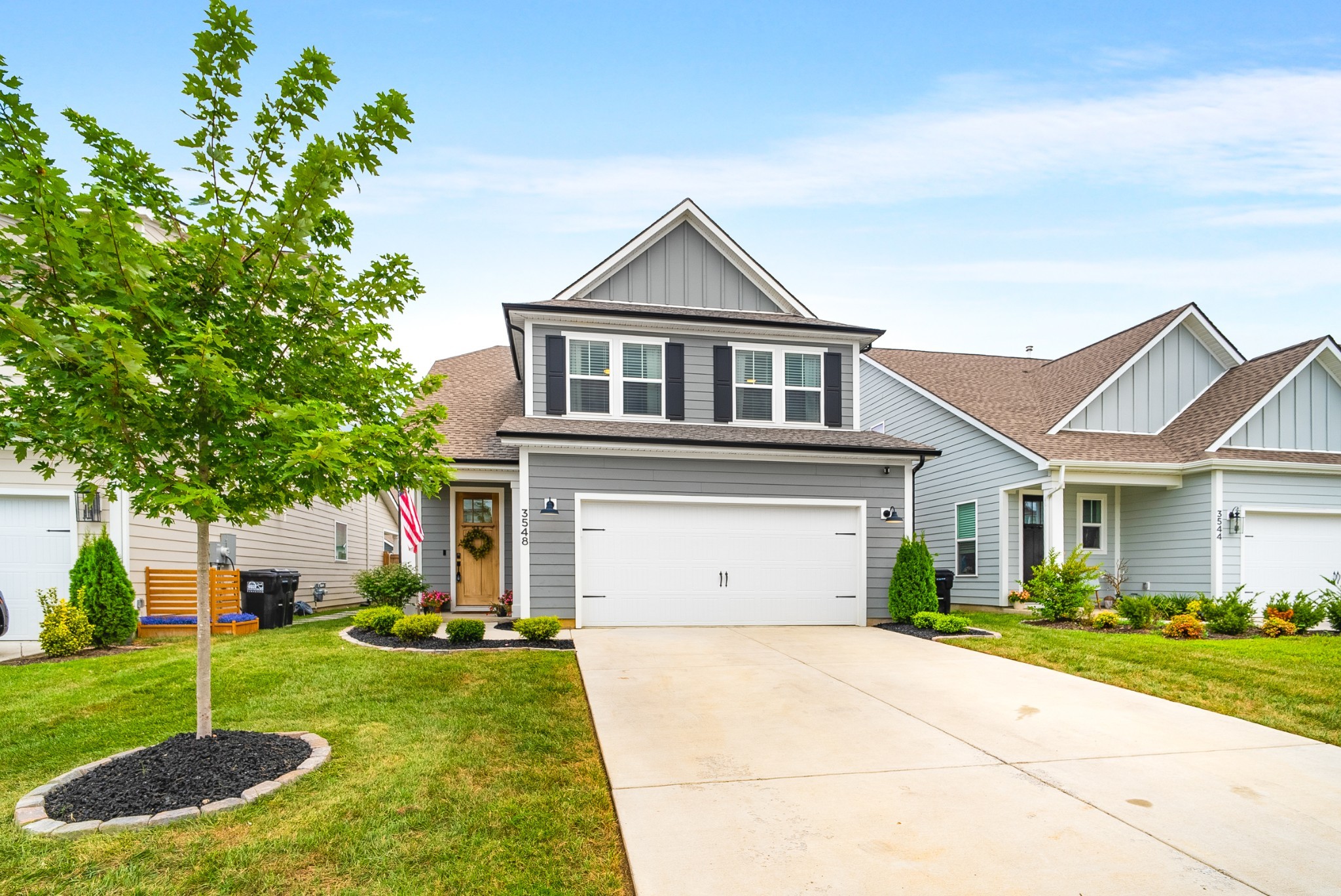 a front view of a house with a yard and garage