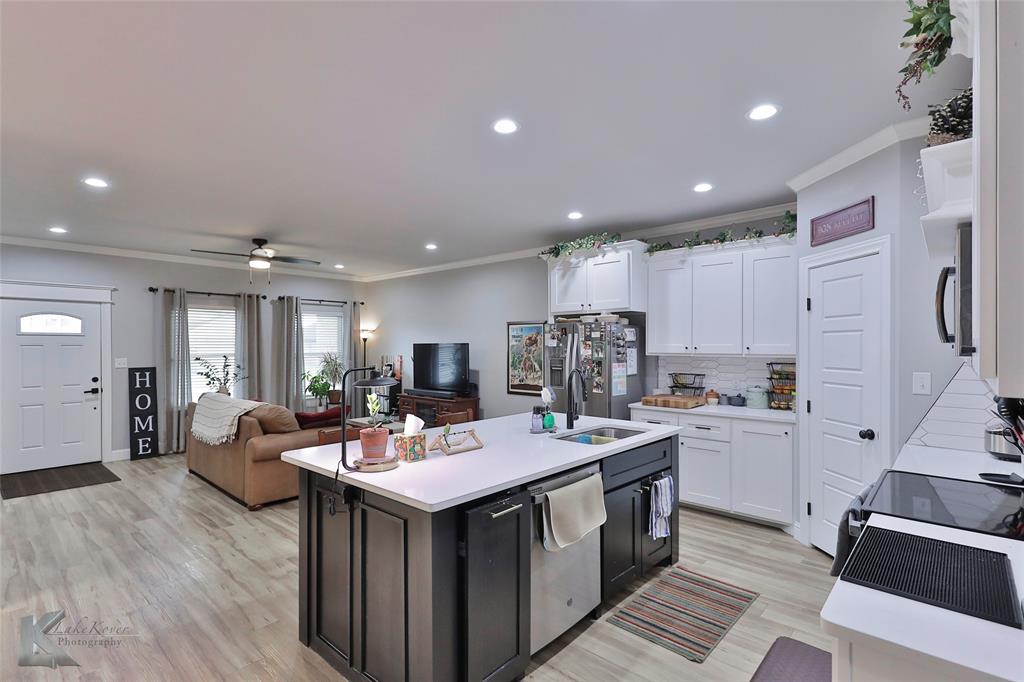 7329 Mountain View Road Abilene, TX 79602 - Photo 12 of 33 a kitchen with kitchen island a sink appliances and a living room