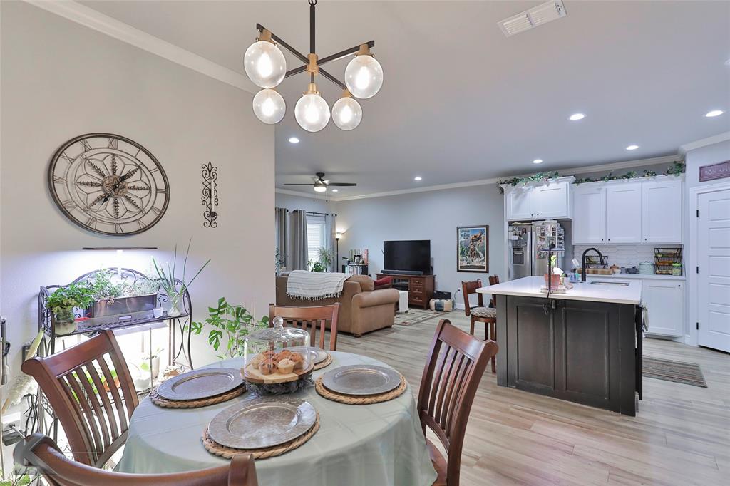 7329 Mountain View Road Abilene, TX 79602 - Photo 14 of 33 a kitchen with stainless steel appliances a table chairs and a chandelier