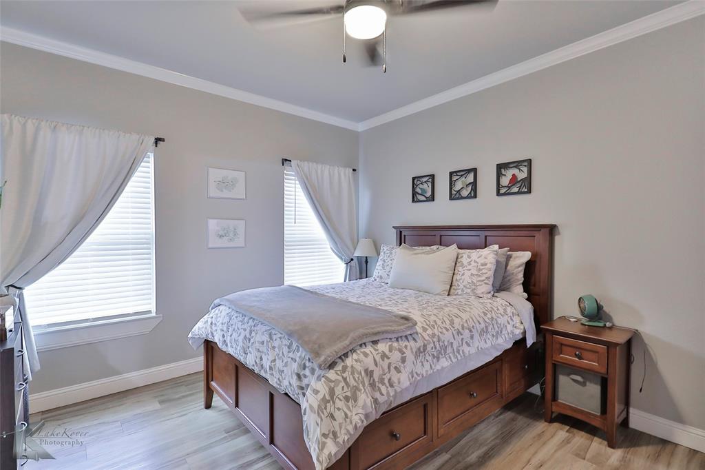 7329 Mountain View Road Abilene, TX 79602 - Photo 17 of 33 a bedroom with a bed and a chandelier