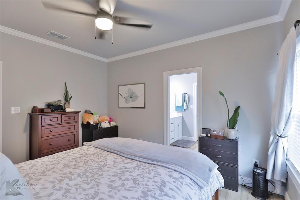 7329 Mountain View Road Abilene, TX 79602 - Photo 18 of 33 a bedroom with a bed and wooden floor