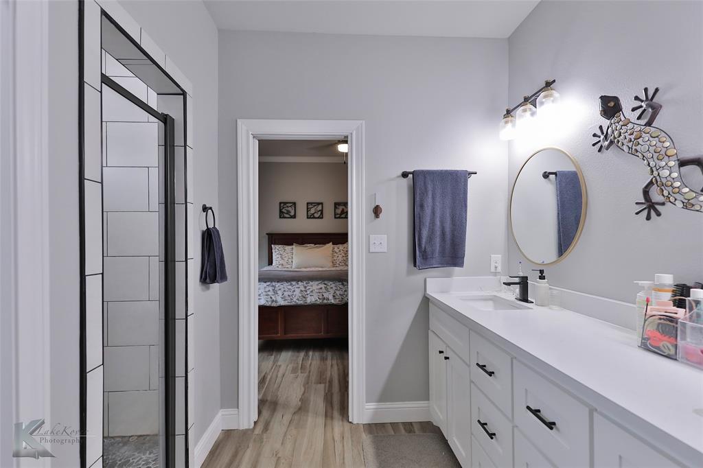 7329 Mountain View Road Abilene, TX 79602 - Photo 22 of 33 a en suite bathroom with a sink double vanity and a mirror