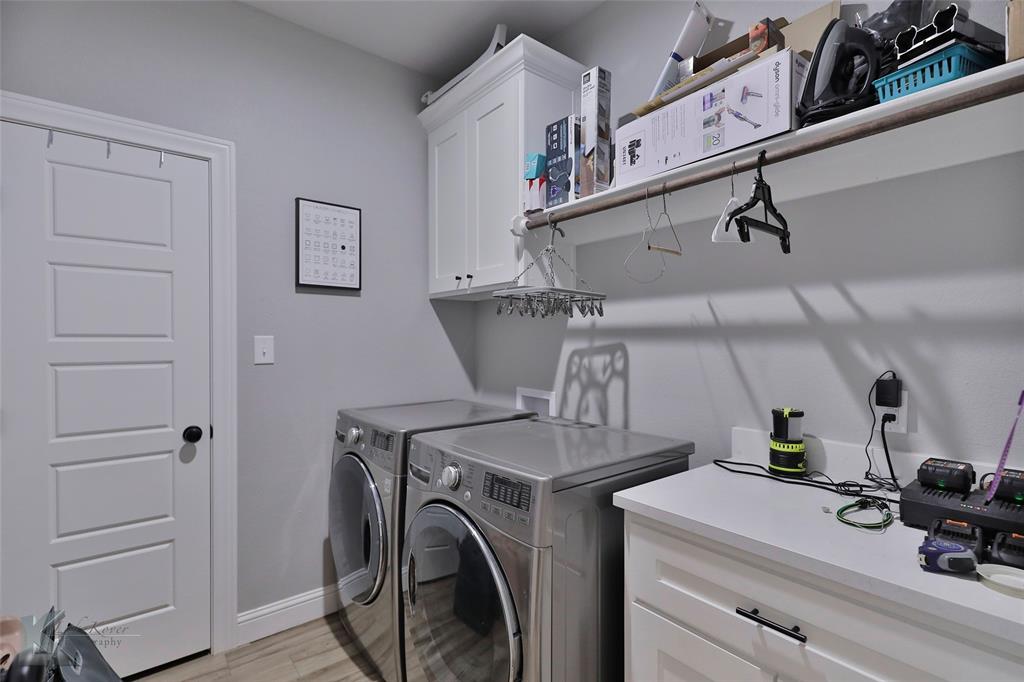 7329 Mountain View Road Abilene, TX 79602 - Photo 23 of 33 a view of storage and utility room with washer and dryer