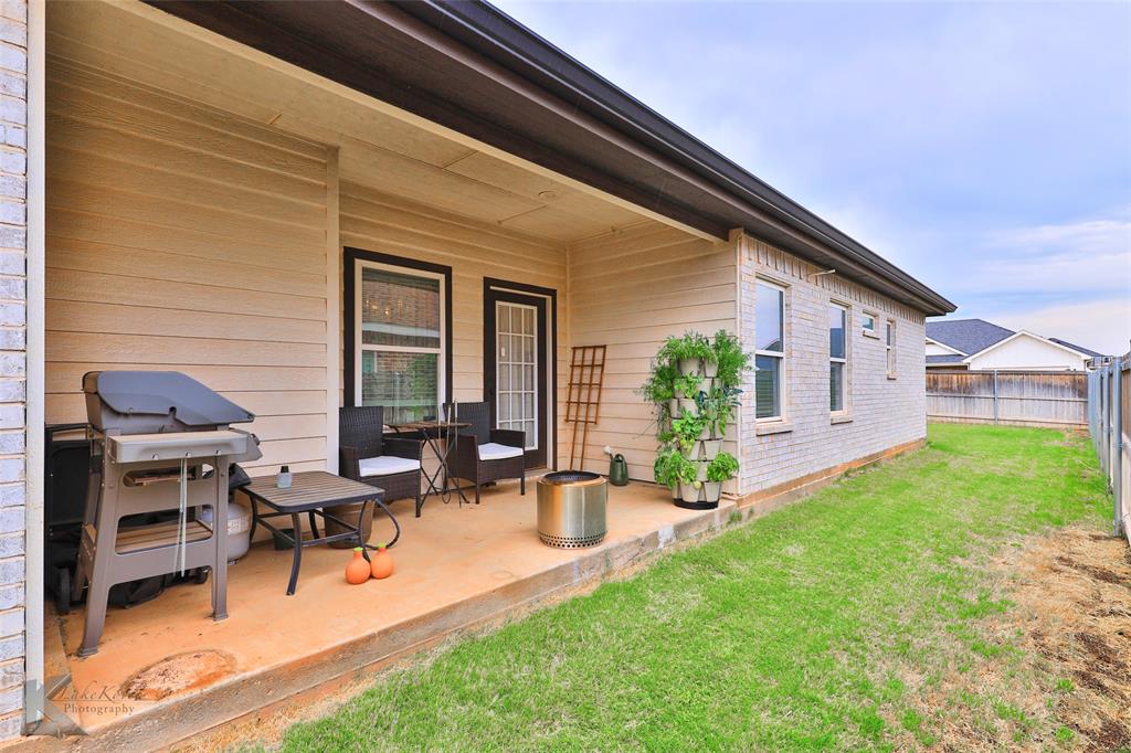 7329 Mountain View Road Abilene, TX 79602 - Photo 31 of 33 a view of a backyard with table and chairs and a barbeque